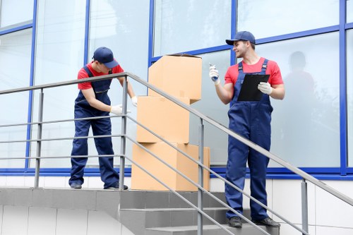 Removal team preparing a London home move with boxes and furniture