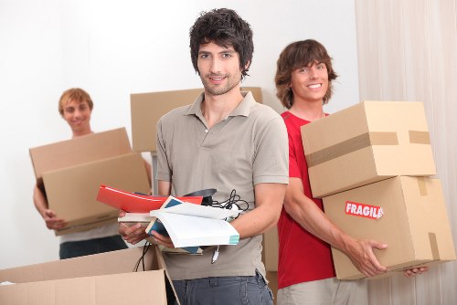 Removal team packing and protecting furniture for a London house move