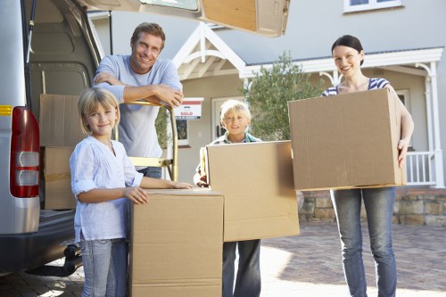 Two movers loading furniture and boxes for a flat move