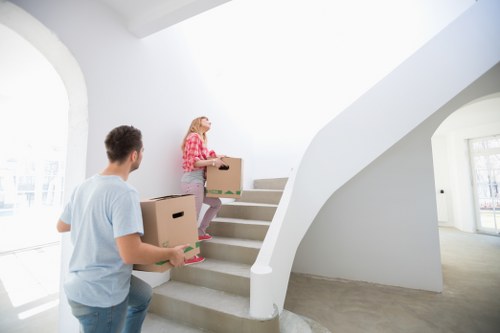 Local London removals team handling packed boxes and furniture