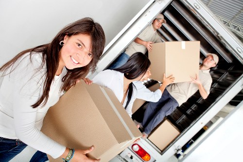 Local movers navigating narrow access at a London property