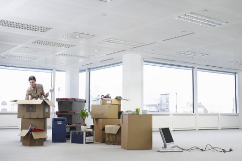 Local movers unloading boxes and furniture at a London property