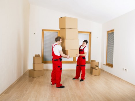 Packed office equipment and furniture ready for commercial relocation